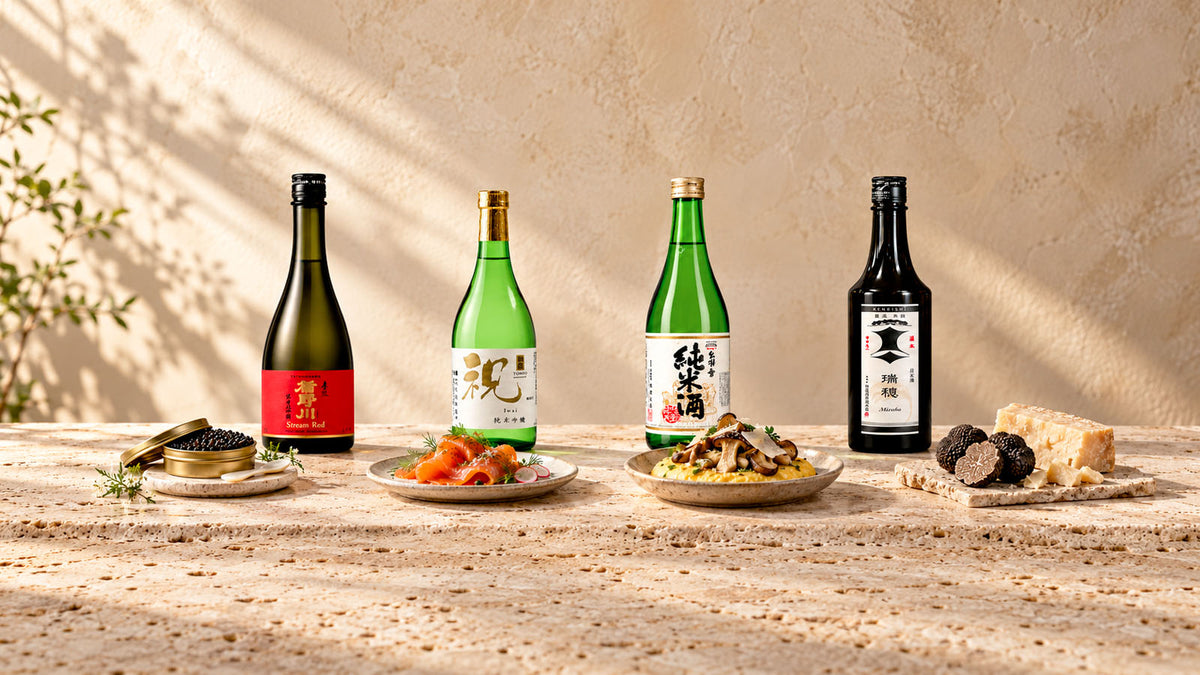 Quattro sake sul travertino con caviale, salmone affumicato, polenta con funghi e formaggi, tartufo e stagionato. Composizione illustrativa.